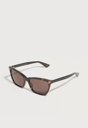 Tortoiseshell rectangular sunglasses with dark brown lenses and gold Gucci logo accents on the front corners.
