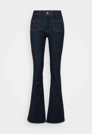 Mørkeblå slengbukser i denim med høy midje, fem lommer og kontrastsøm langs sømmene. Glatt tekstur.