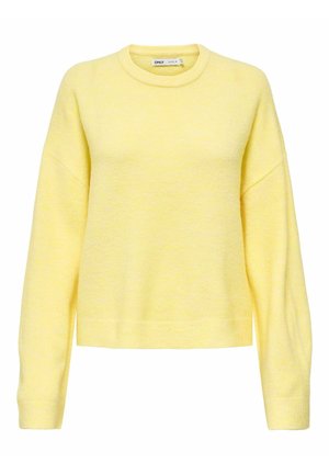 Keltainen, teksturoitu neulepaita pyöreällä pääntiellä ja valetaskuilla. Siinä on pitkät hihat ja istuva helma rentoa istuvuutta varten.