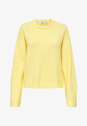 Keltainen, teksturoitu neulepaita pyöreällä pääntiellä ja valetaskuilla. Siinä on pitkät hihat ja istuva helma rentoa istuvuutta varten.