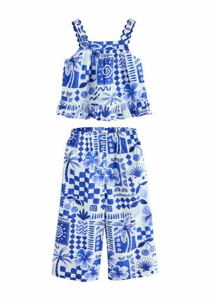Niebiesko-biała tropikalna bluzka bez rękawów z falbankami oraz spodnie o szerokich nogawkach z elastycznym paskiem dla dzieci.