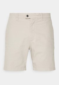 Beige bomullsshorts med rak front, knäppe och två sidofickor. Rakt klippt nederkant med en slät yta.