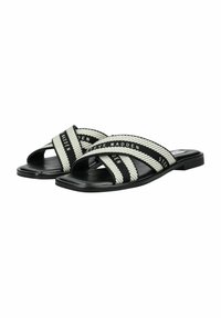 Sandales à glisser noires et blanches avec des brides croisées, en tissu texturé, avec une semelle en caoutchouc plate et des détails de logo.