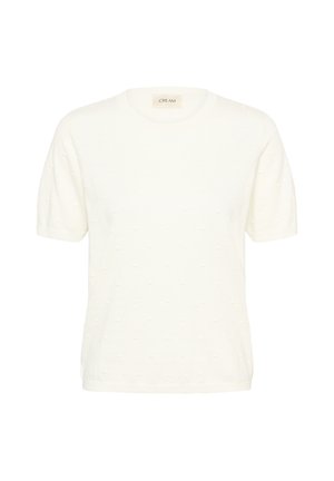 Krém színű rövid ujjú kötött felső kerek nyakkivágással és finom, texturált pöttyös mintával, fehér háttéren bemutatva.