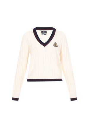 Cream cable-knit sweater with a v-neck, featuring navy accents on the collar and hem, and a decorative patch on the chest.