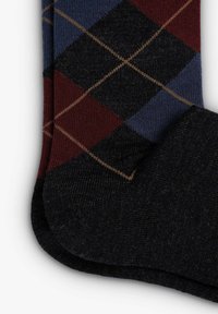 Black socks featuring a diamond pattern in maroon, blue, and brown. The texture appears soft and knitted, with a smooth finish.