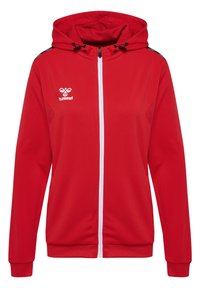 Rotkapuzenjacke mit durchgehendem Reißverschluss und weißem Reißverschluss, ausgestattet mit einem strukturierten Stoff und schwarzen Akzenten an den Schultern. Hummel-Logo sichtbar.
