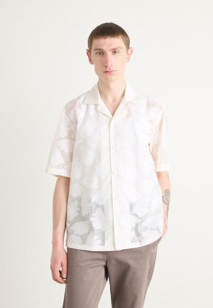 Short-sleeve button-up shirt in sheer white fabric with subtle floral patterns, featuring a classic collar and a relaxed fit.