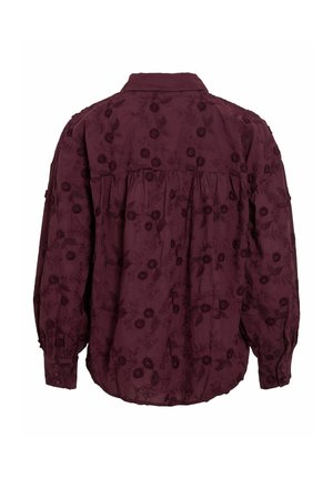 Blouse bordeaux avec broderie florale, manches longues, coupe décontractée, détail de boutons sur les poignets et col rabattu. La vue arrière montre un design froncé.