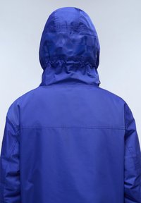 Blue waterproof jacket with a hood, featuring a cinched neck and smooth texture. The back displays a subtle logo pattern.