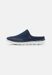 Navy slip-on shoes with a mesh upper, gray accents, and a lightweight white sole. Features a textured surface for breathability and comfort.