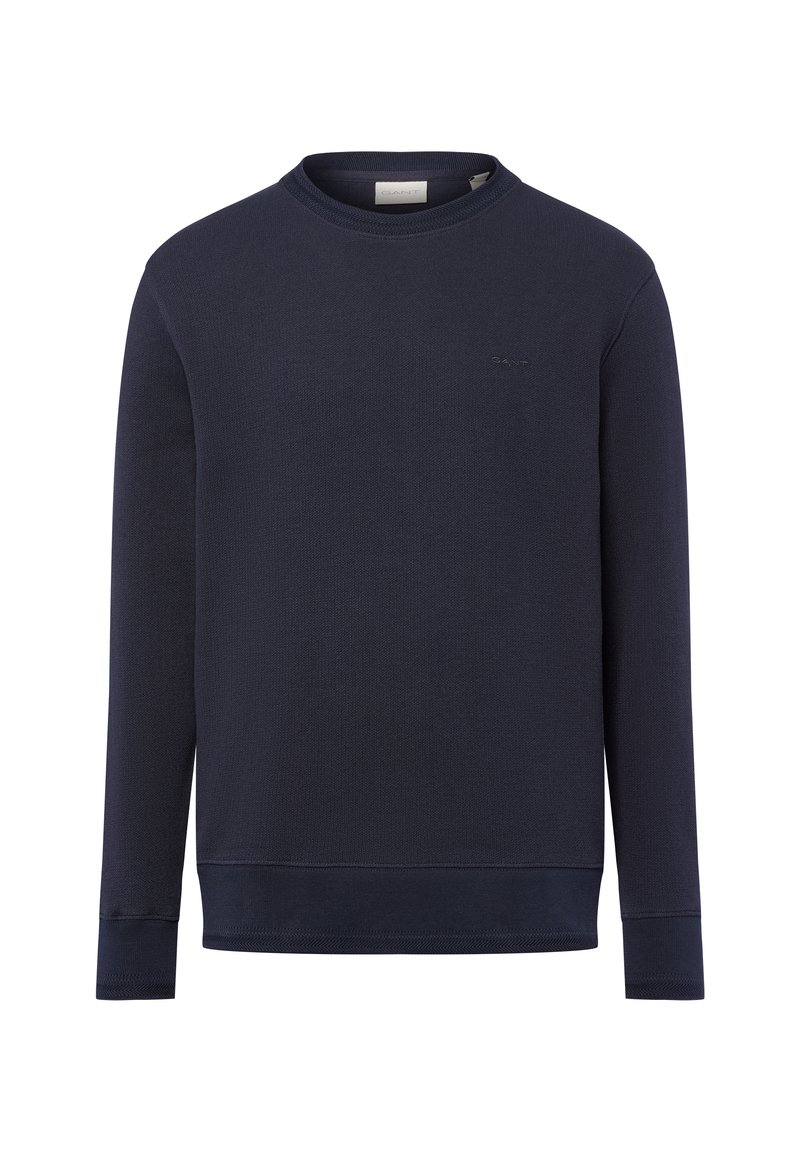 Marineblaue Langarm-Pullover im Crewneck-Stil mit gerippten Bündchen und Saum, dezentes Logo auf der linken Brust gestickt.