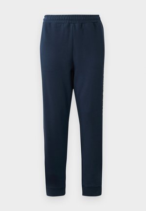 Navy blue joggers made of soft fabric, featuring an elastic waistband and tapered legs. Displayed logo along the side.