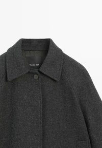 Dark gray wool coat featuring a notched collar, a single button closure, and side pockets. Smooth texture with minimalist design elements.