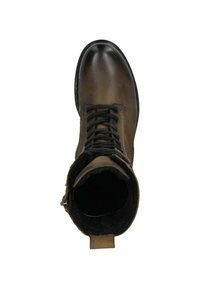 Bottine en cuir brun avec une pointe ronde, un laçage à l'avant et une doublure en fourrure douce visible au niveau du col. Semelle en caoutchouc noir.