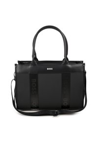 Bolsa tote preta com duas alças e faixa de ombro ajustável. Apresenta material suave e letras em negrito. Fecho com zipper na parte superior.