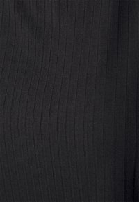 Black ribbed fabric featuring vertical stripes, characterized by a stretchy texture and smooth finish, suitable for various clothing applications.