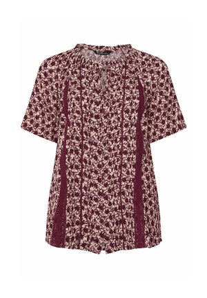 Korte mouwen blouse in bordeaux met een bloemenpatroon. Beschikt over een keyhole-halslijn en contrasterende zijpanelen in een textuurstof.