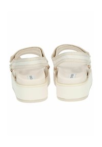 Sandali platform beige con ampie cinghie in tessuto, chiusura alla caviglia regolabile e soletta testurizzata. Suola bianca liscia.