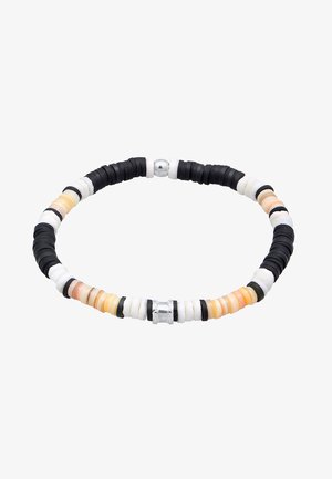 Black, white, and orange circular beads alternate with silver accents in a flexible, patterned bracelet. Smooth texture, varied sizes.