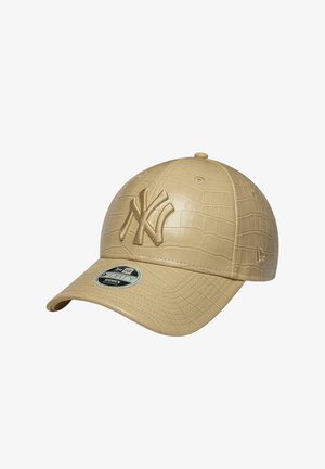 Beżowa teksturowana czapka baseballowa z tłoczonym logo New York Yankees z przodu i zakrzywionym daszkiem z naklejką.