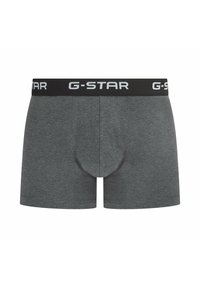 Gray cotton boxer shorts featuring a black elastic waistband with white "G-STAR" branding and a fitted design for comfort.