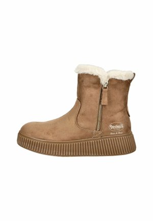 Beige Wildleder-Stiefeletten mit flauschigem weißen Futter, seitlichem Reißverschluss und geriffelter Gummisohle. Logo auf der Außenseite sichtbar.