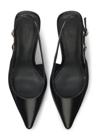 Black leather slingback flats with pointed toes, scalloped edges, and a gold-tone buckle detail. Smooth texture and minimalist design.