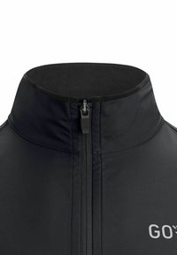 Black zip-up jacket with a high collar, featuring a smooth texture and a front zipper. Logo prominently displayed on the lower right side.