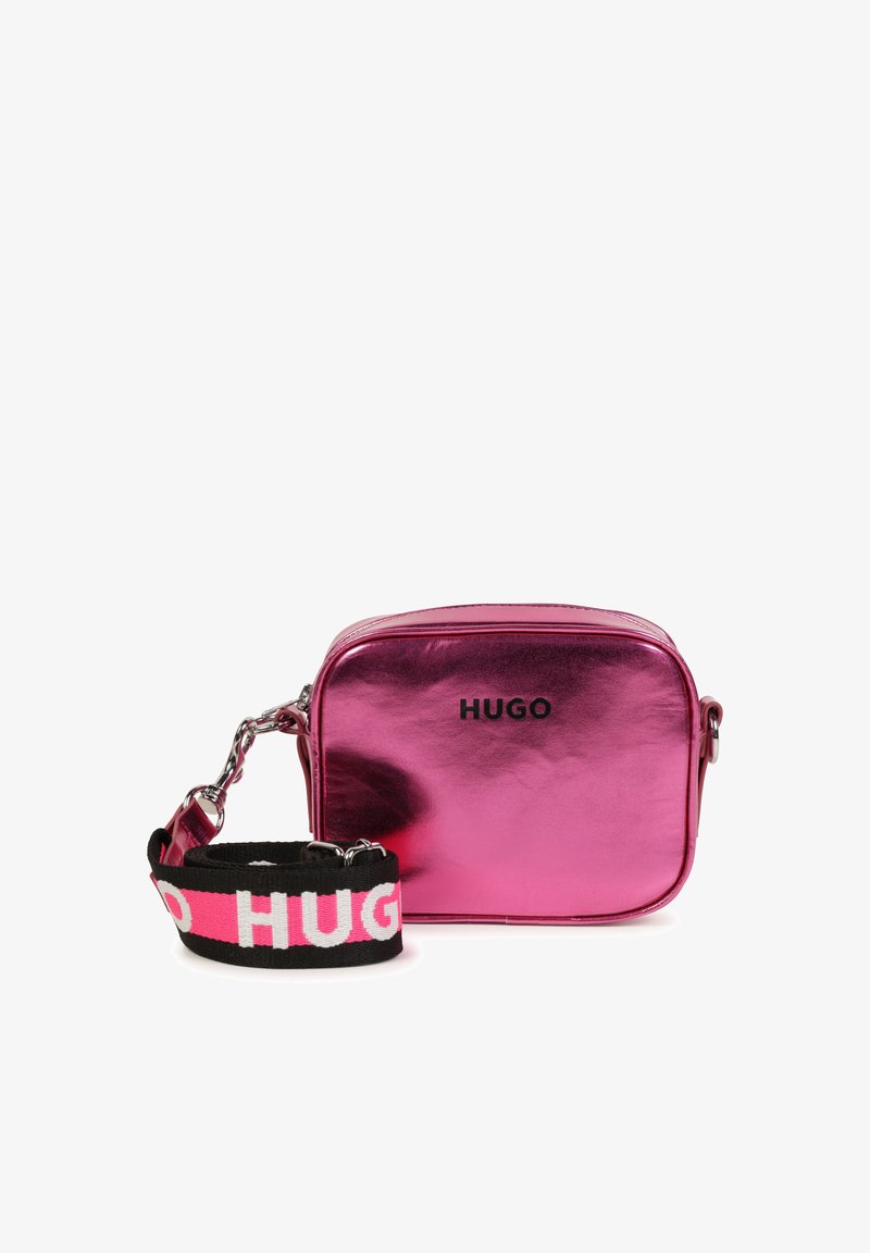Metallic pink crossbody bag with black fabric strap featuring "HUGO" in white. Rectangular shape, zip closure, and shiny surface.