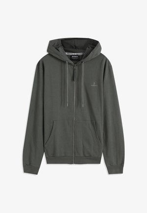 Sweat à capuche zippé vert foncé en tissu doux, avec une poche frontale, une capuche à cordon ajustable et un petit logo sur la poitrine.