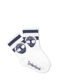 Calzini di cotone bianchi con strisce blu navy sulla parte superiore, caratterizzati da un logo circolare con un albero e il testo "Timberland" in blu navy.
