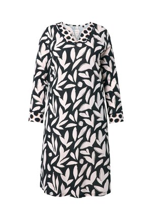 Langærmet kjole med sort base og hvide bladmønstre. Tekstureret krave med prikker. Løs pasform og knælængde.