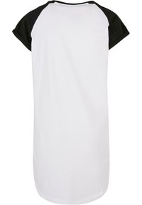 Valkoinen t-paita mekko mustilla raglan-hihansuilla, pyöreä kaula-aukko ja pehmeä puuvillapinta. Pitkä ja rento malli, sileä ompelutaito.