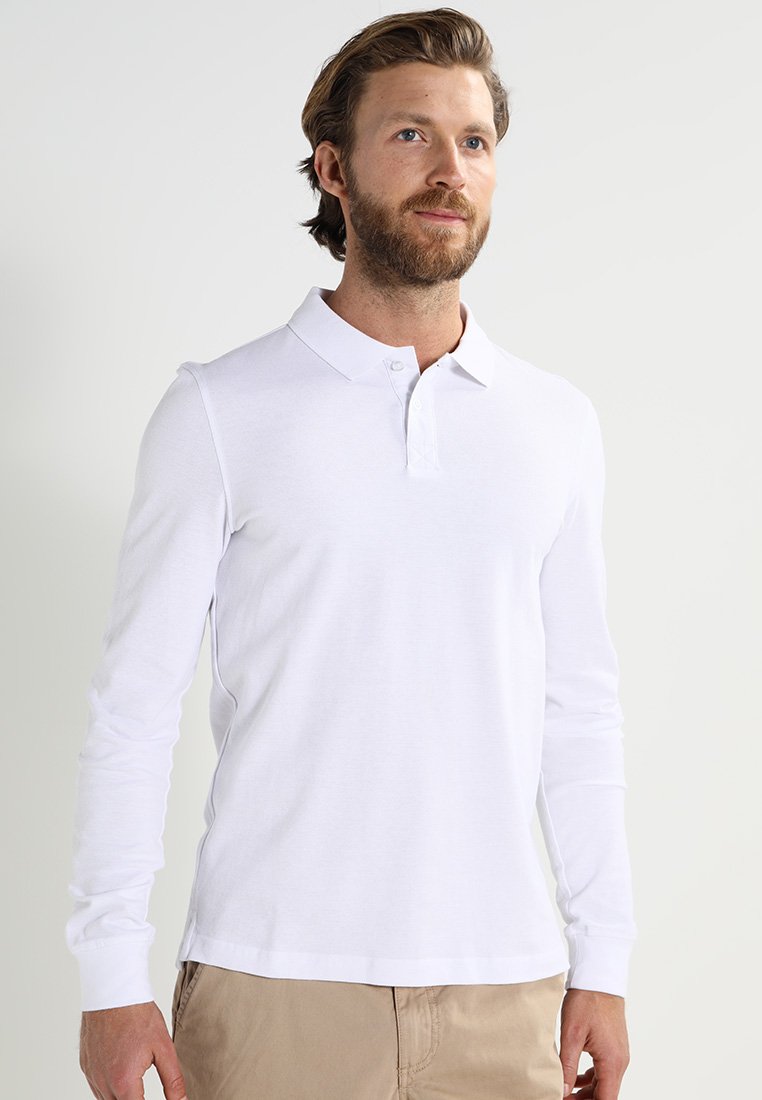 Long-sleeve white polo shirt, made of lightweight fabric, features a classic collar, button placket, and a relaxed fit.