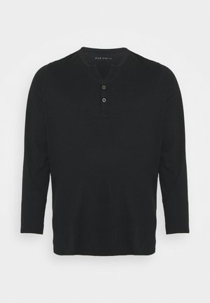 Schwarzes Henley-Shirt mit langen Ärmeln aus weicher Baumwolle, mit dreiknöpfiger Knopfleiste und abgerundetem Saum. Einfaches Design ohne Muster oder Akzente.