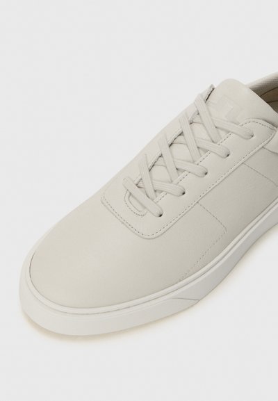 Light gray leather sneaker with a smooth texture, round toe, flat lace closure, and subtle stitching details on the side.