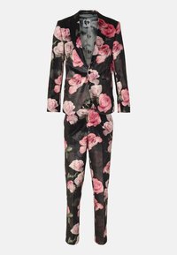 Black floral velvet suit with pink and white rose patterns. Features a two-button blazer with a shawl collar and matching tapered trousers.