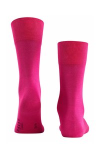 Calze rosa fino al ginocchio realizzate in tessuto morbido con polsini a coste. Presentano una punta senza cuciture e un logo del marchio stampato vicino alla base.