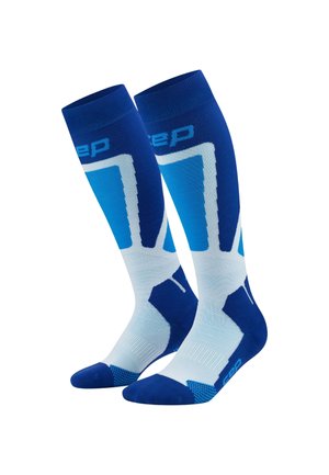 Kompressionssocken in Blau und Weiß, mit geometrischem Muster, schlankem Design, strukturiertem Stoff sowie verstärkten Zehen- und Fersenbereichen.