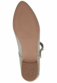Sola di scarpa beige con un design liscio e arrotondato. Presenta un motivo testurizzato e un logo a forma di farfalla. Il materiale sembra morbido con una leggera lucentezza.