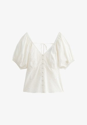 Weiße Bluse mit Puffärmeln, V-Ausschnitt und Schleife im Rücken. Sie verfügt über eine Knopfleiste auf der Vorderseite und ein ausgeschnittenes Blumenmuster im Stoff.