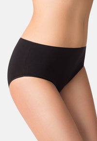 Slip in cotone nero con un design liscio e senza cuciture, dotato di un elastico in vita a media altezza e dettagli di cucitura minimi.