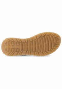 Suola delle scarpe Gabor in un materiale gommoso beige e texturizzato. Presenta scanalature orizzontali e verticali per una maggiore aderenza, con una stampa a rilievo del nome del marchio.