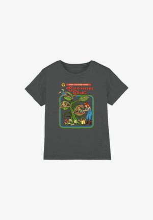 Dark gray shirt with cartoon showing a girl feeding a large carnivorous plant with people inside its open mouths. Text reads "How to feed your Carnivorous Plant."