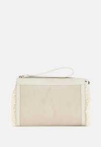 Beżowa torba z gładkim zamszowym przodem i teksturowanym bokiem z owczej skóry, wyposażona w zamek błyskawiczny oraz odpinany paskiem na nadgarstek.