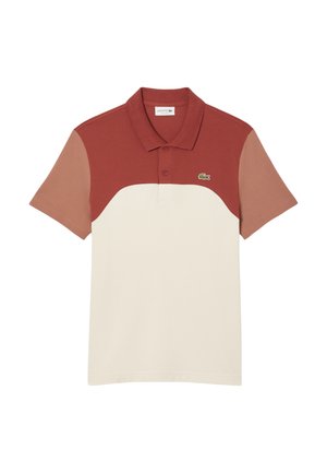 Pikepaita punaisena, vaaleana ja kermana. Lyhyet hihat värilohkoyksityiskohdalla, kaulus, kolmen napin lista ja Lacosten logo vasemmassa rinnassa.