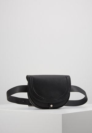 Black leather belt bag with curved flap, embossed brand name, and silver snap button closure, displayed on a white pedestal.