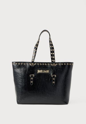 Sac cabas noir texturé avec doubles poignées et œillets dorés, arborant le logo doré "Just Cavalli" à l'avant.