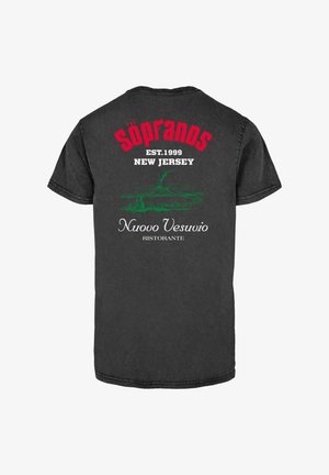 Black cotton t-shirt featuring "THE SOPRANOS" in red, with white text reading "EST. 1999 NEW JERSEY" and "Nuovo Vesuvio RISTORANTE" in white and green graphics.